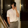Man wearing a slim-fit black short-sleeved knitted ice silk shirt for casual wear.