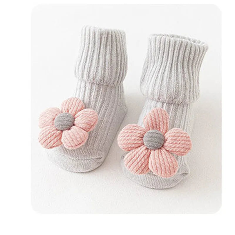 Cotton baby socks with non-slip soles in multiple designs including bows, stars, and animal prints.