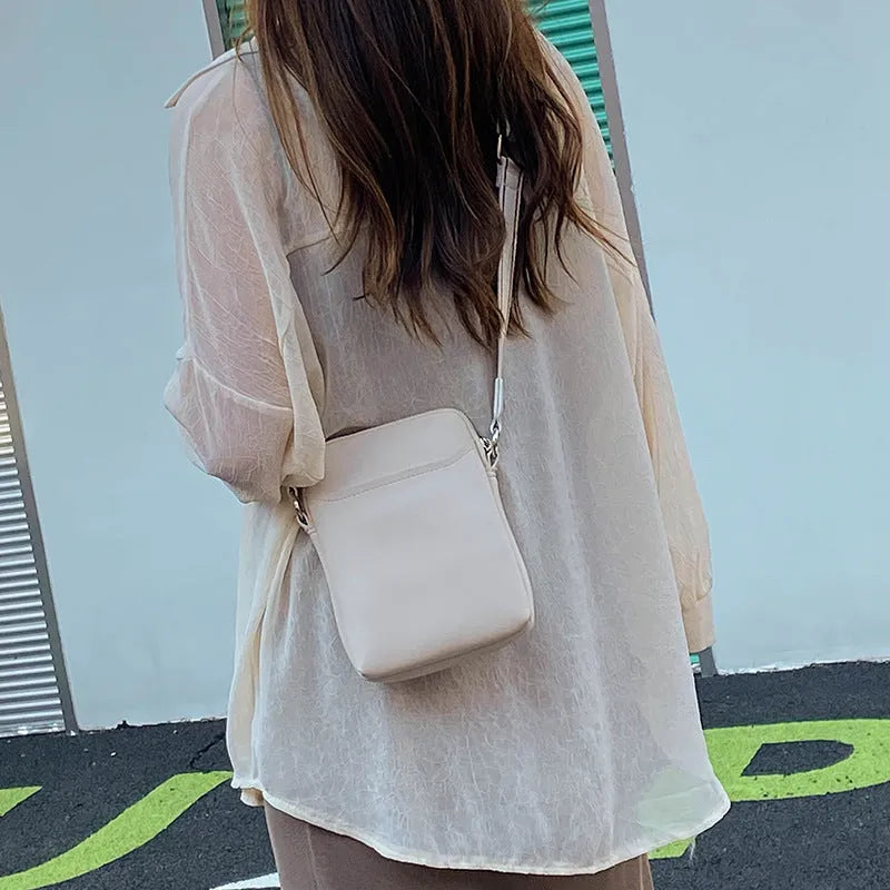 Solid colour small crossbody shoulder bag for mobile phones in beige.