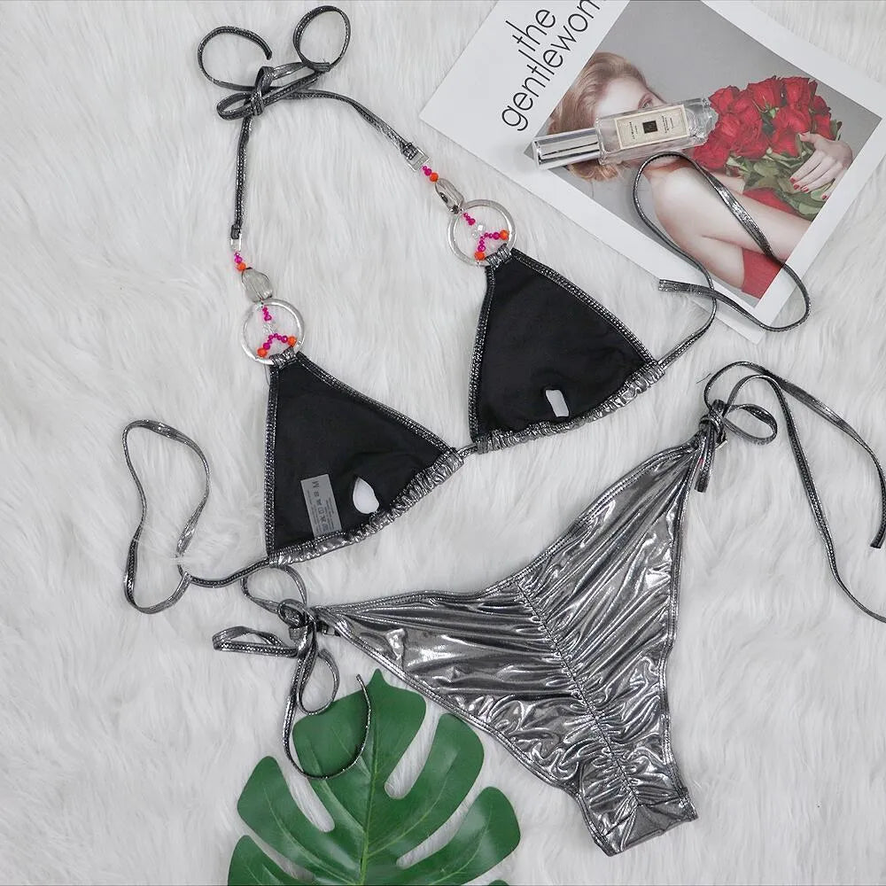 Silver women's bikini swimsuit with split design and briefs style on mannequin