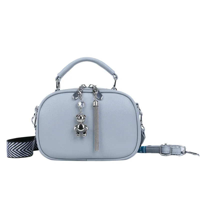 Women's small square stitching bag in PU material showing oval shape and double shoulder straps
