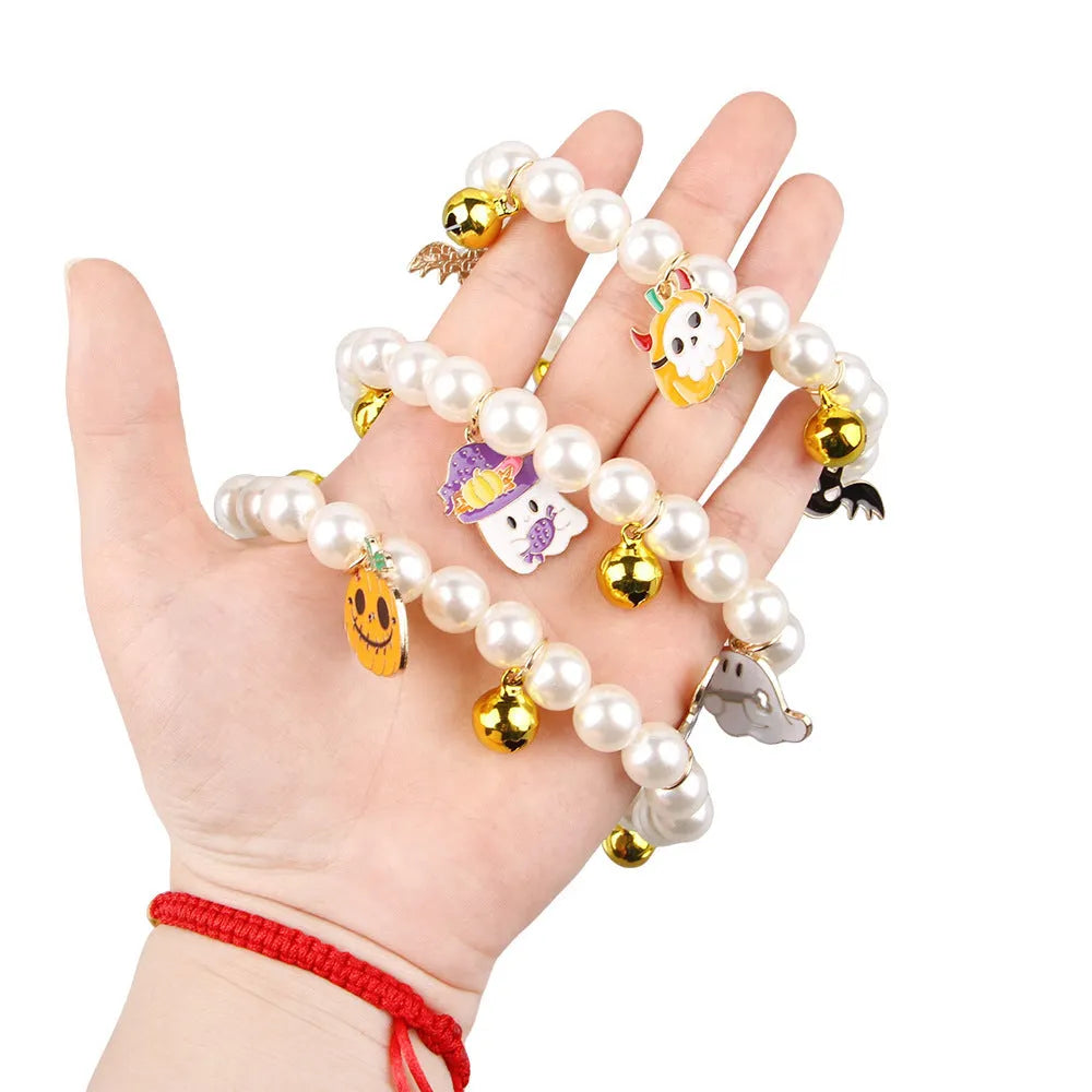 Halloween decorative pet collar with simulated pearls and a choice of pumpkin-themed charms: purple ghost, skull, or smiling.