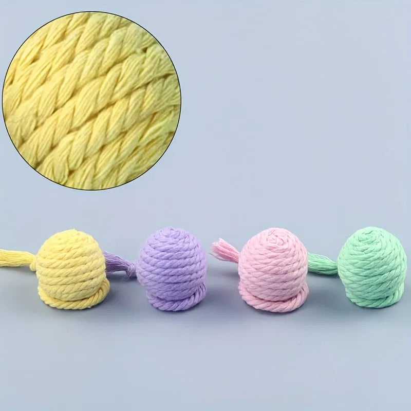 Cat toy ball with rope handle in green, pink, purple or yellow colours with internal bell