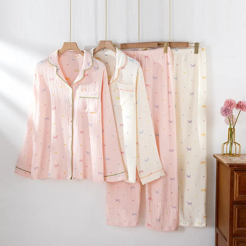 Women's pink cotton pajamas set with long sleeves and trousers on hanger