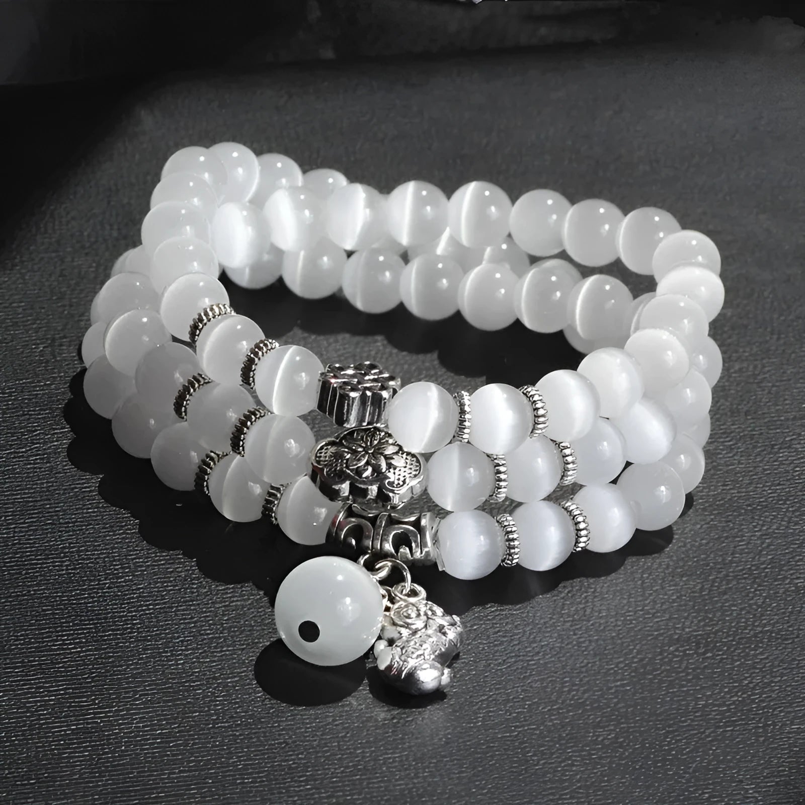 Women's adjustable opal bracelet with Lucky Cat charm and geometric beads in blue.