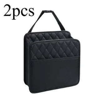 Black leather hanging storage bag attached to a car seat headrest.