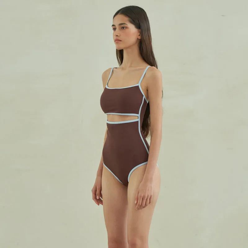Brown triangle one-piece swimsuit for women on a mannequin, showing front design.