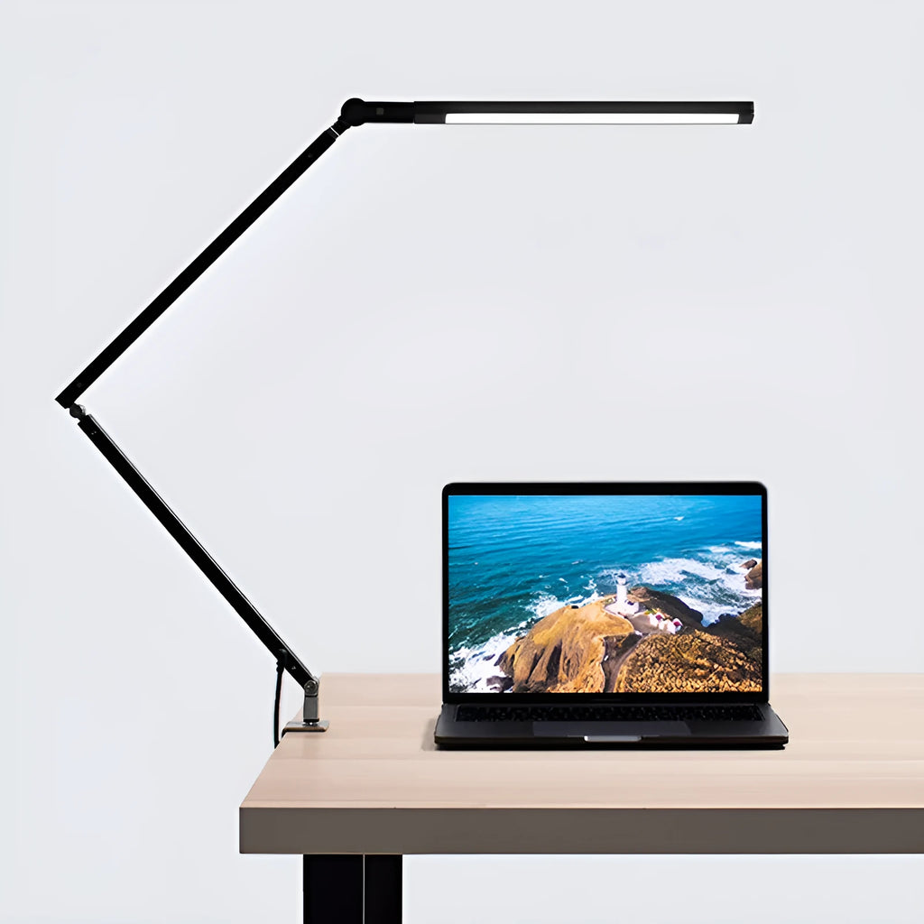 Aluminum clip-on LED desk lamp with dimmer switch mounted on a desk edge.