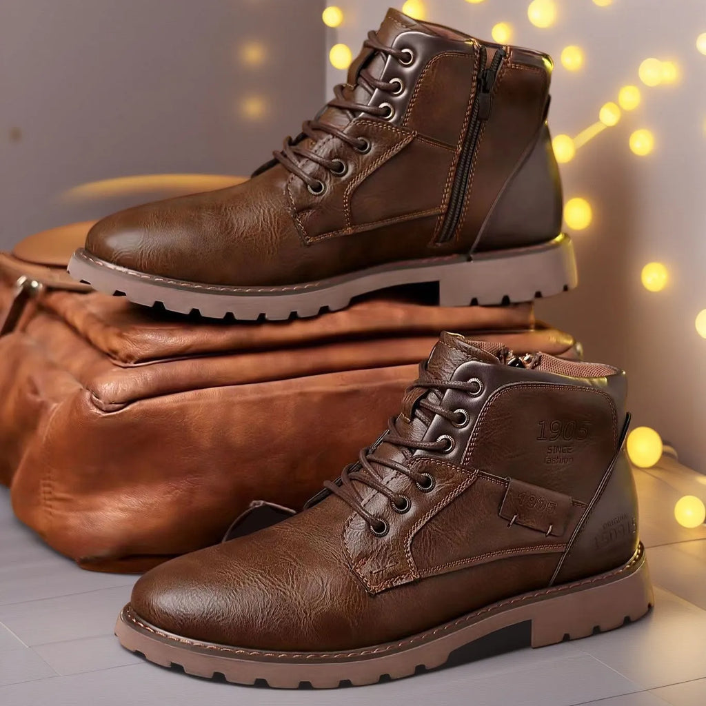Men's brown leather-style ankle boot with a side zip and round toe on a rubber sole.