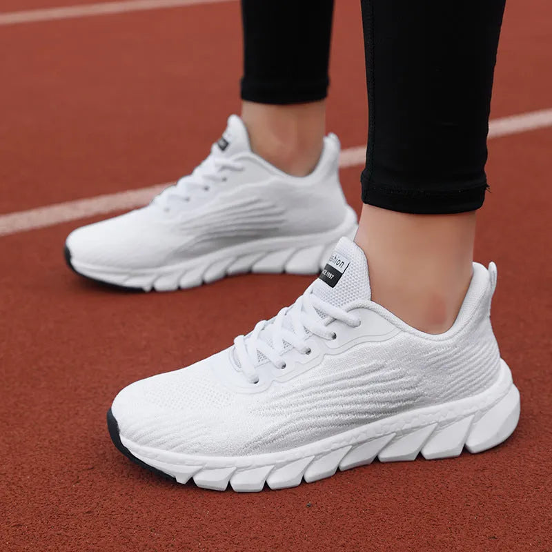 Women's low-top platform sneakers in black and white with cross-strap detail and MD sole.