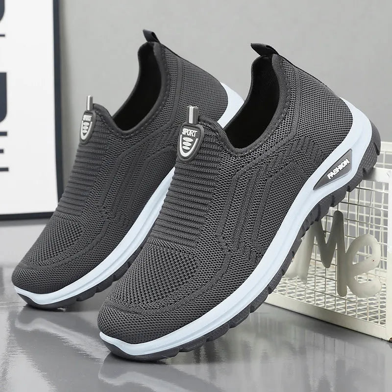 Men's black and grey casual tennis shoes with mesh lining and flat PVC sole.