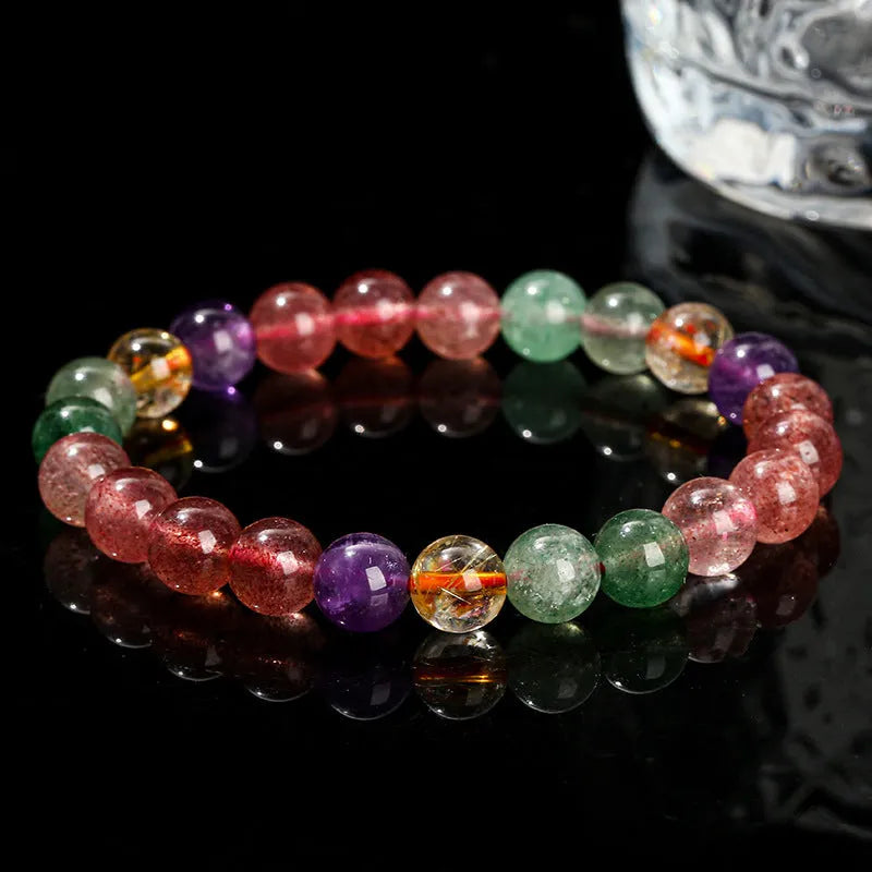 Natural tourmaline colour strawberry quartz bracelet with geometric round beads on a wrist.