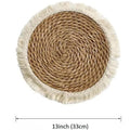 Round Japanese straw placemat with tassel edge in natural papyrus material on wooden dining table