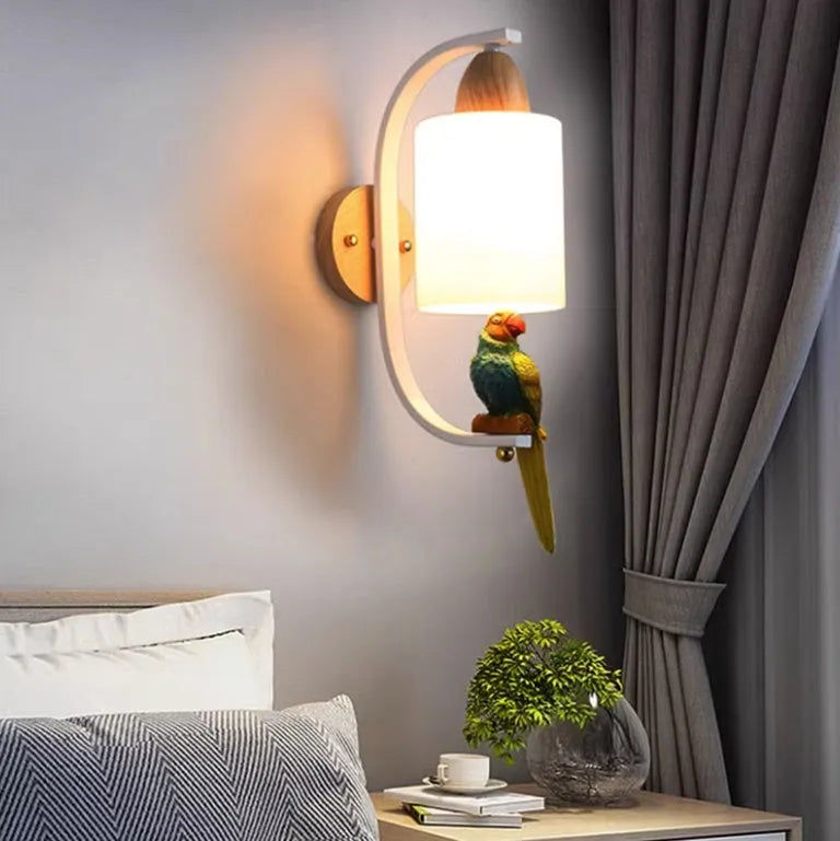 Resin bird wall lamp with iron body, wood accent, and glass lampshade on a wall