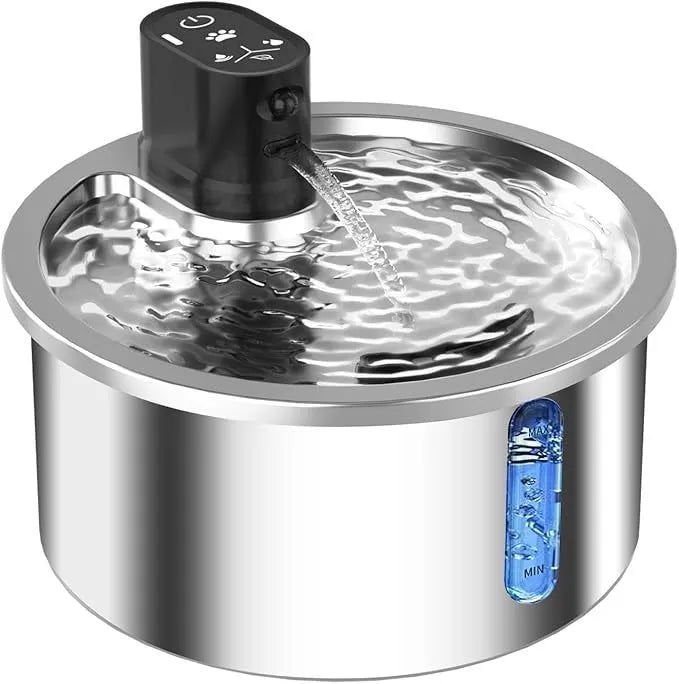 White stainless steel heated pet water fountain on a table with charging cable.
