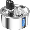 White stainless steel heated pet water fountain on a table with charging cable.