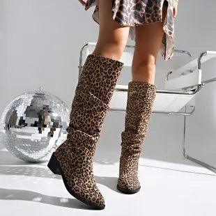 Brown women's leopard print ankle boots with a square toe and chunky mid-heel on a plain background.