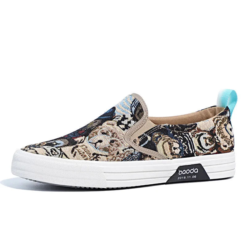 A pair of low-top canvas slip-on sneakers with a round toe and vulcanised rubber sole on a neutral background.