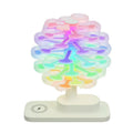 Modern geometric spiral tree shaped LED desk lamp on a wooden surface