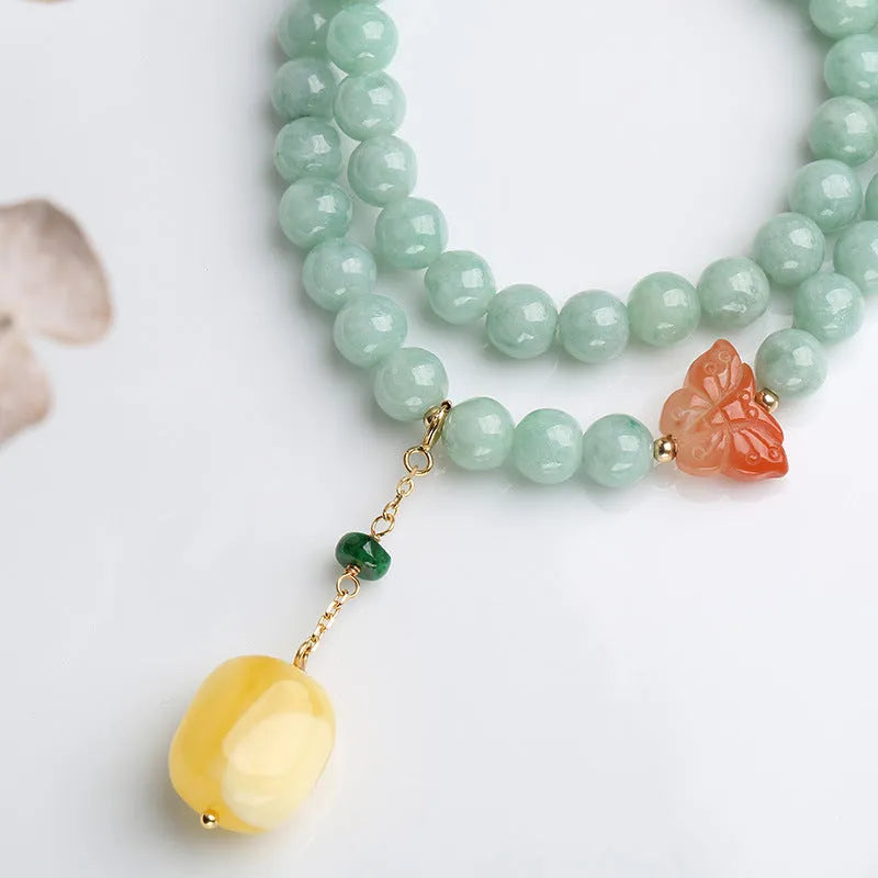 Double-layer retro bracelet with emerald jade round beads and hanging beeswax barrel beads.