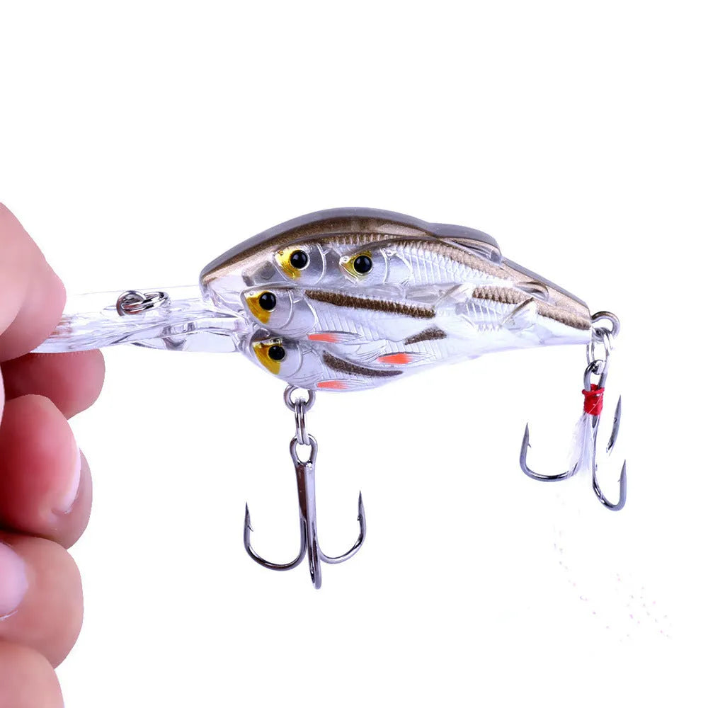 Sea fishing hard bait lure with feather hooks floating on water surface