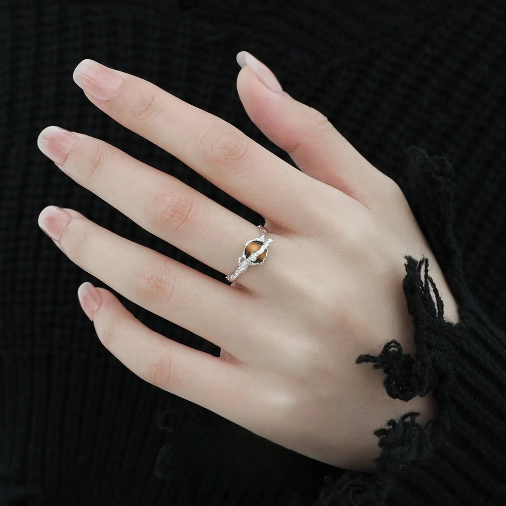 Saturn design adjustable silver ring with white gold electroplated finish and tigereye open pattern