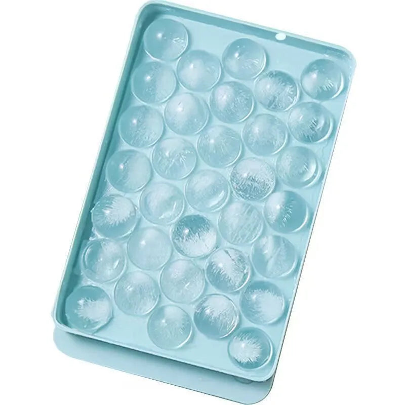 Blue silicone ice cube tray with lid showing 33 round cavities for large ice.