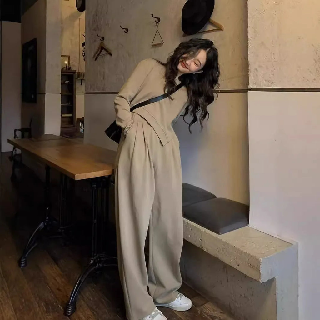 Women's khaki coloured loose-fit casual sports suit with long sleeves and trousers on a hanger.