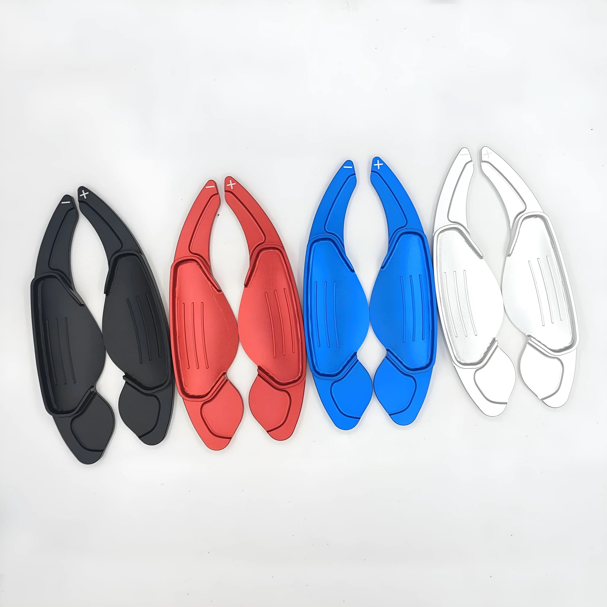 Aluminium alloy steering wheel shift paddles in silver, red, blue, and black for universal car interior modification.