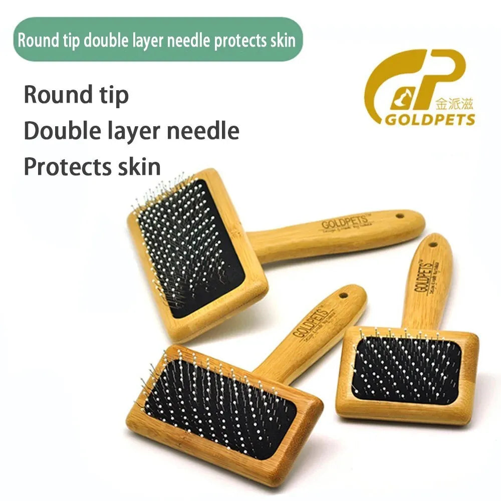 Goldpets bamboo and wood pet slicker brush with stainless steel pins on a wooden table.