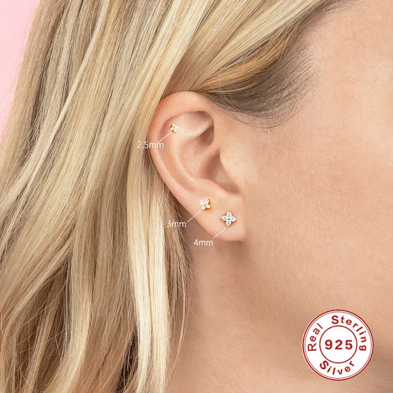 S925 sterling silver stud earrings with geometric flower petal and crystal design in gold and platinum finishes.