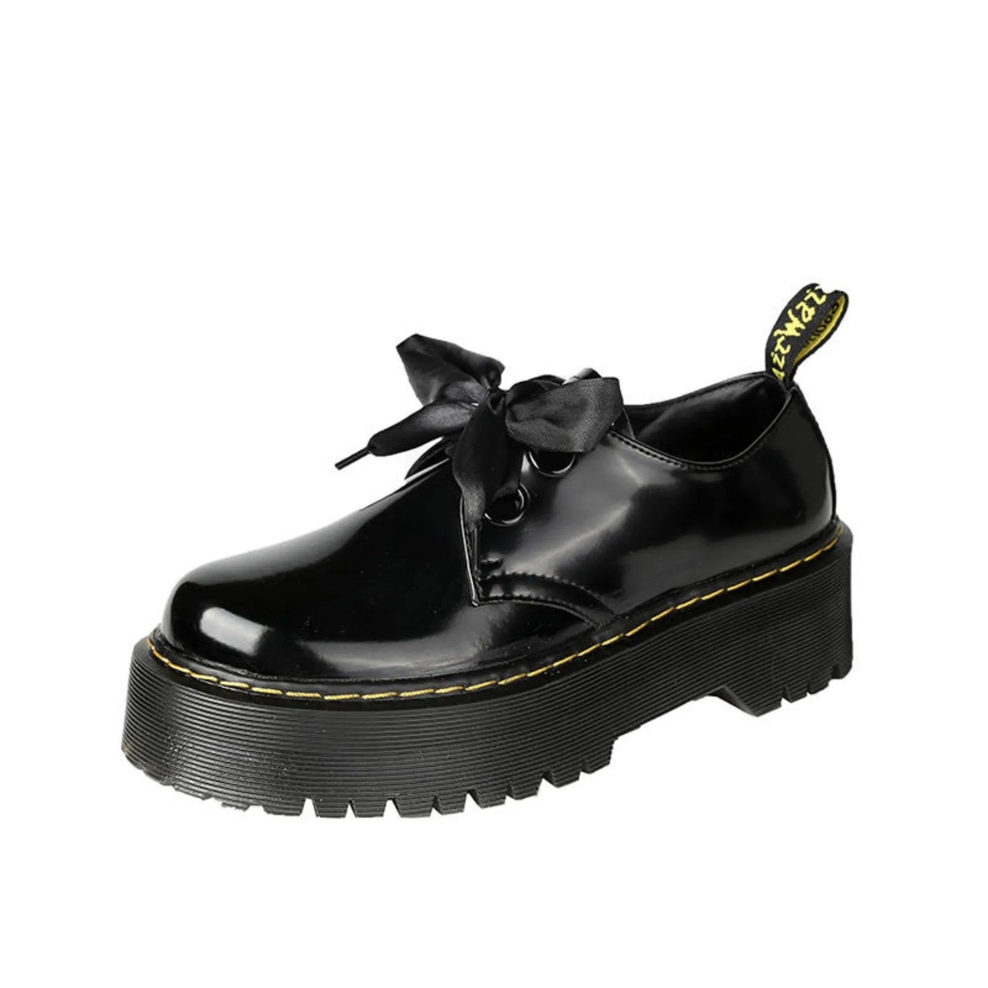 Black and white women's lace-up shoes with a thick sole, cross straps, and ribbon details.