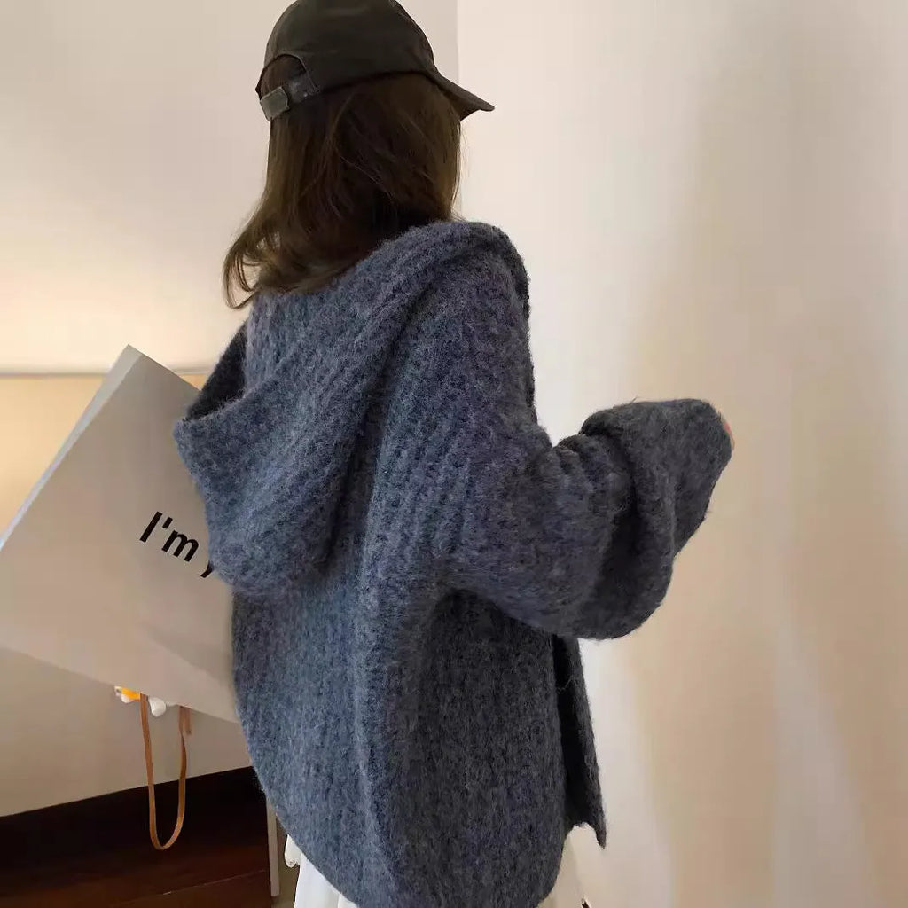 Woman wearing a dark grey retro knit Maillard pattern hooded cardigan