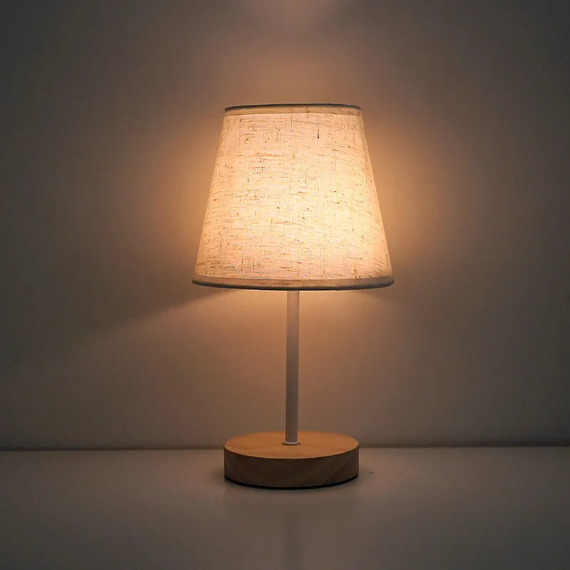 Solid wood fabric bedside lamp with rechargeable touch dimming and three colour light options on a nightstand