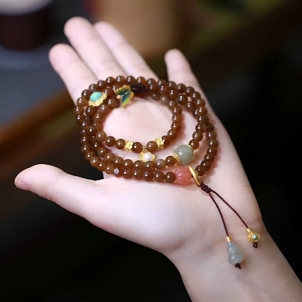 Brown jade Hetian jade women's bracelet with silver accents in a geometric three-ring design.