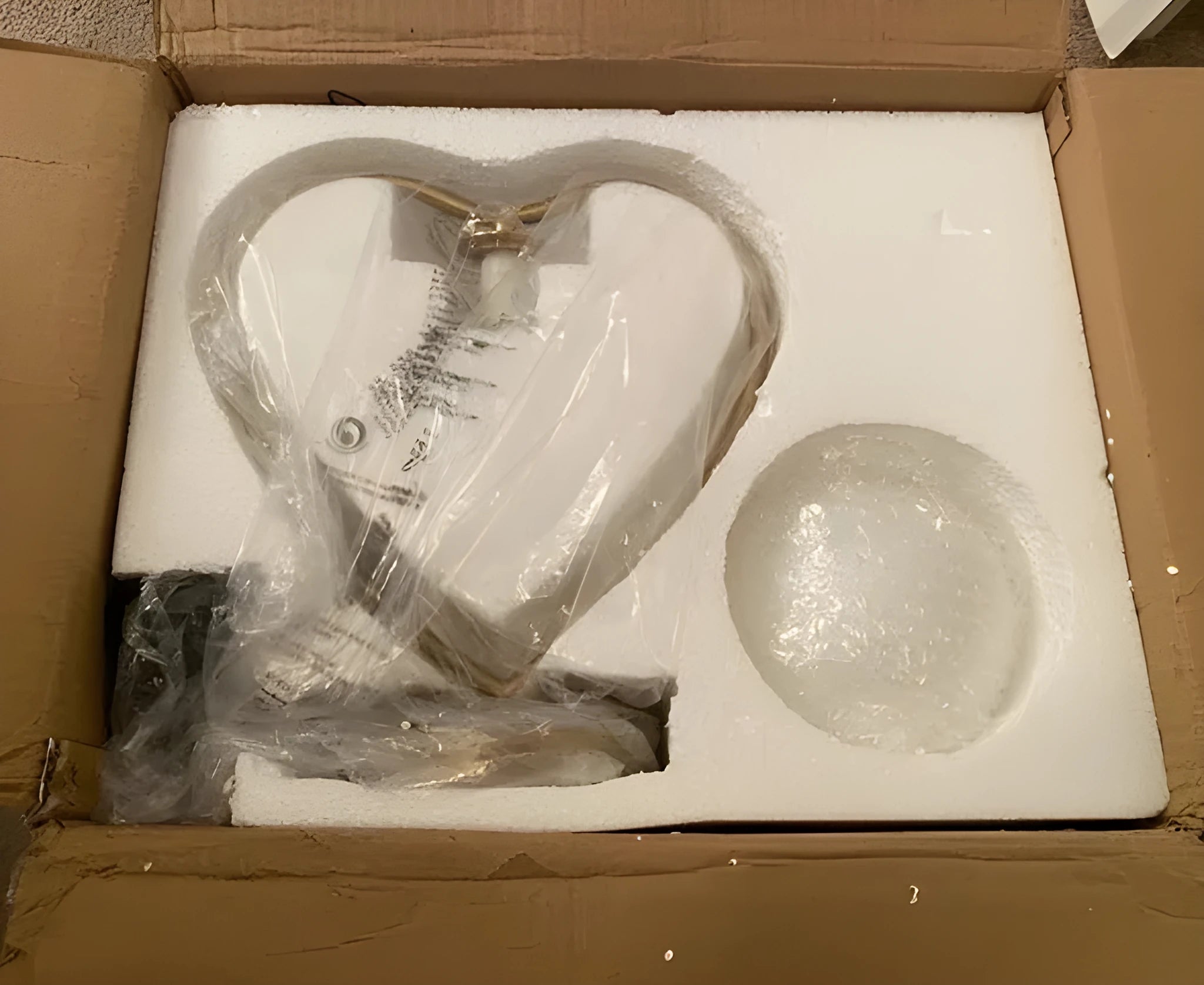 Heart shaped white decorative LED lamp with warm lighting on tabletop