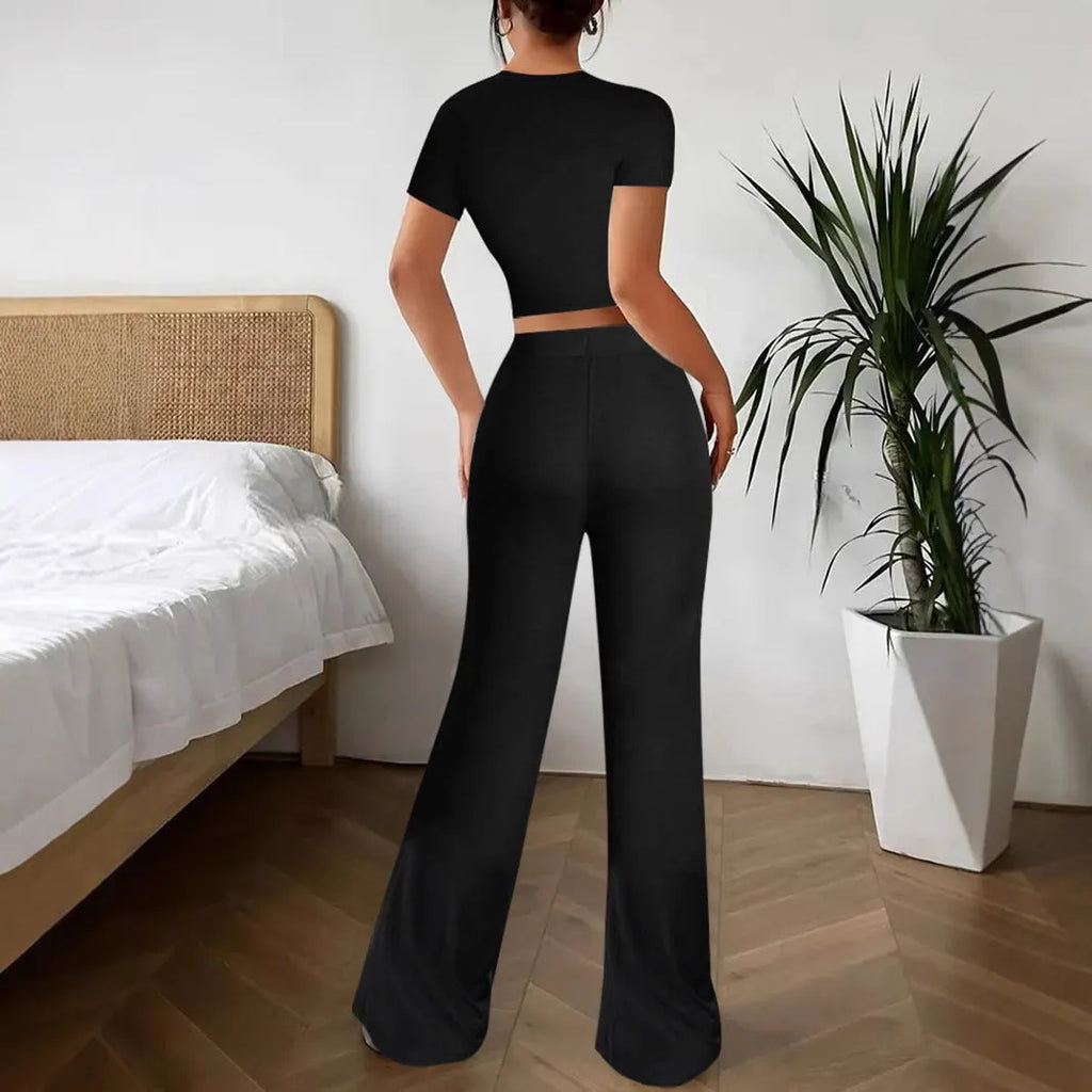 Black high-waist trousers and regular-sleeve T-shirt matching set for women laid flat.