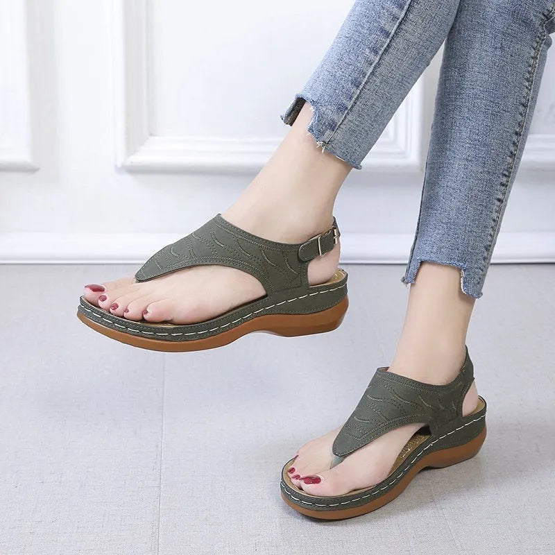Women's red wedge heel sandals with an adjustable back strap buckle.