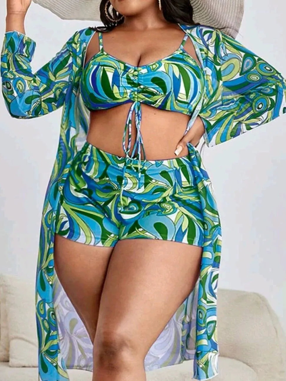Women's floral print polyester bikini set with bra, briefs, and cardigan.