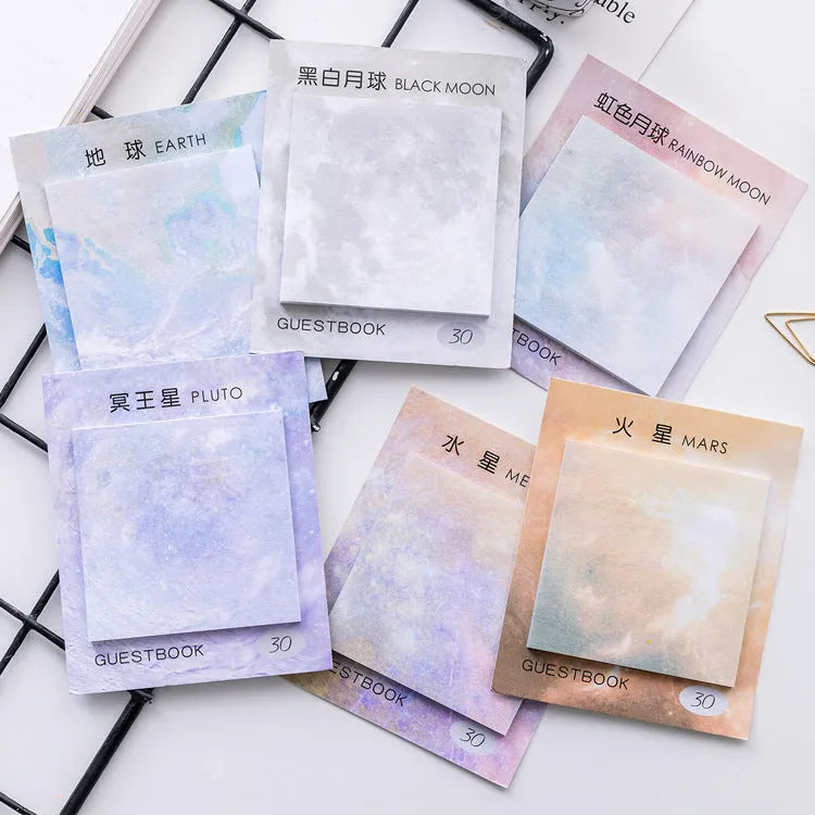 Square planet sticky notes pad showing celestial oil painting designs in six colour variations