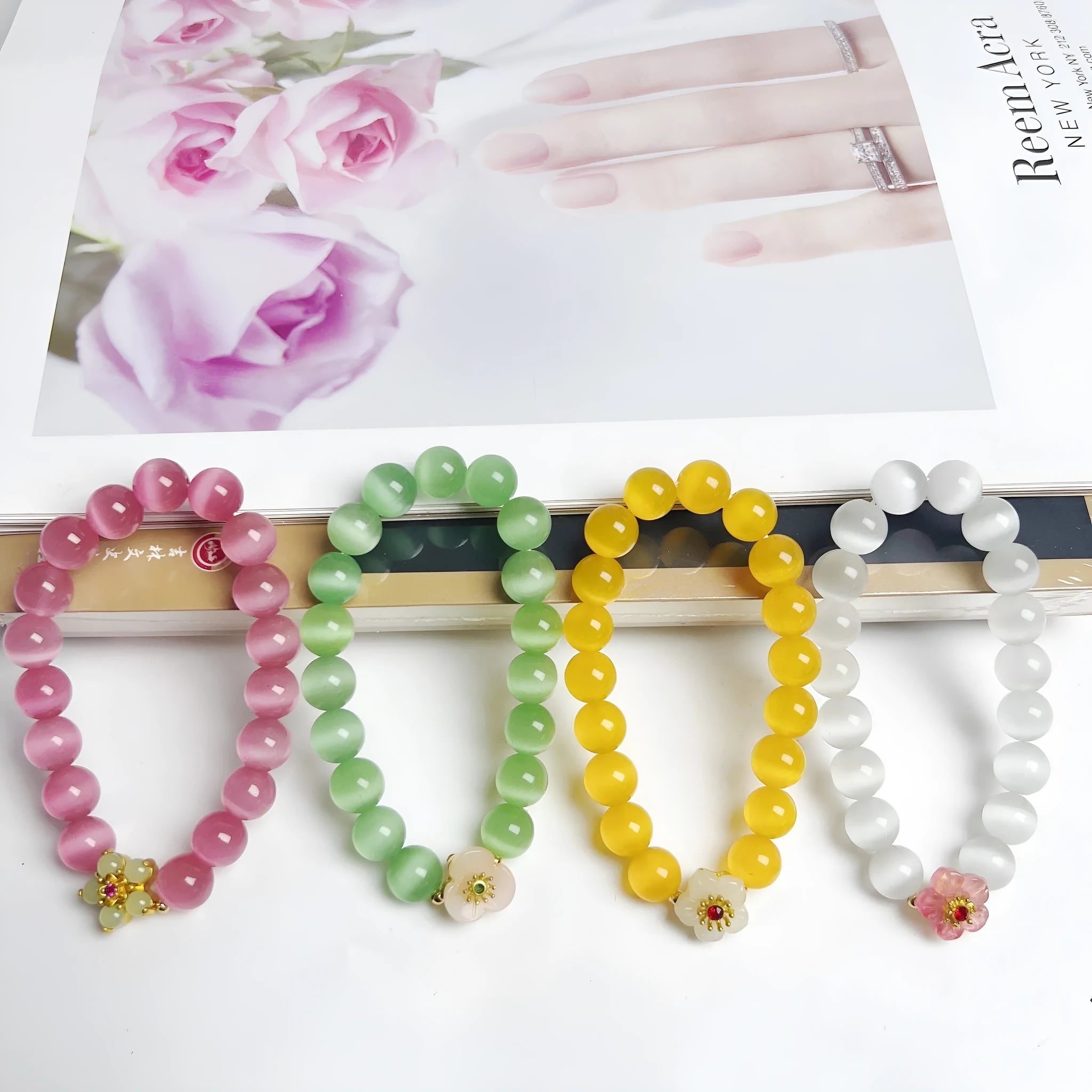 Handmade glass bead bracelet with floral design in yellow, pink, white, or green.