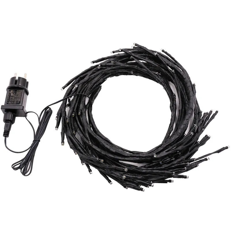 Warm white LED tree decorative light with rattan-style string and choice of plug type.