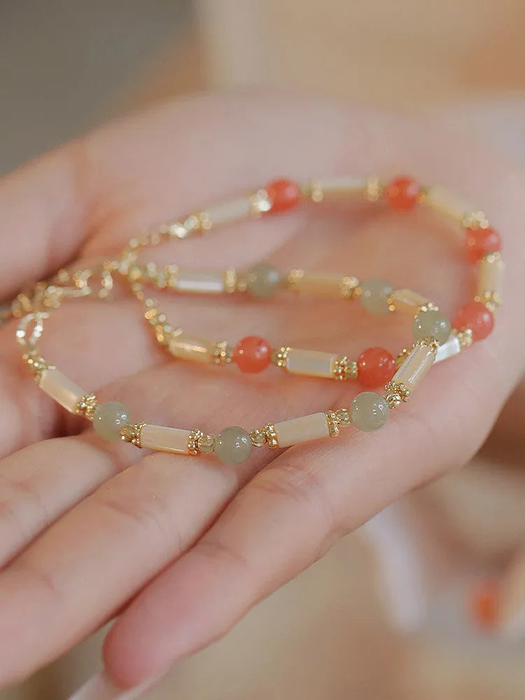 Women's Hetian jade bamboo joint bracelet in 6mm size, shown in jade and South red colours.