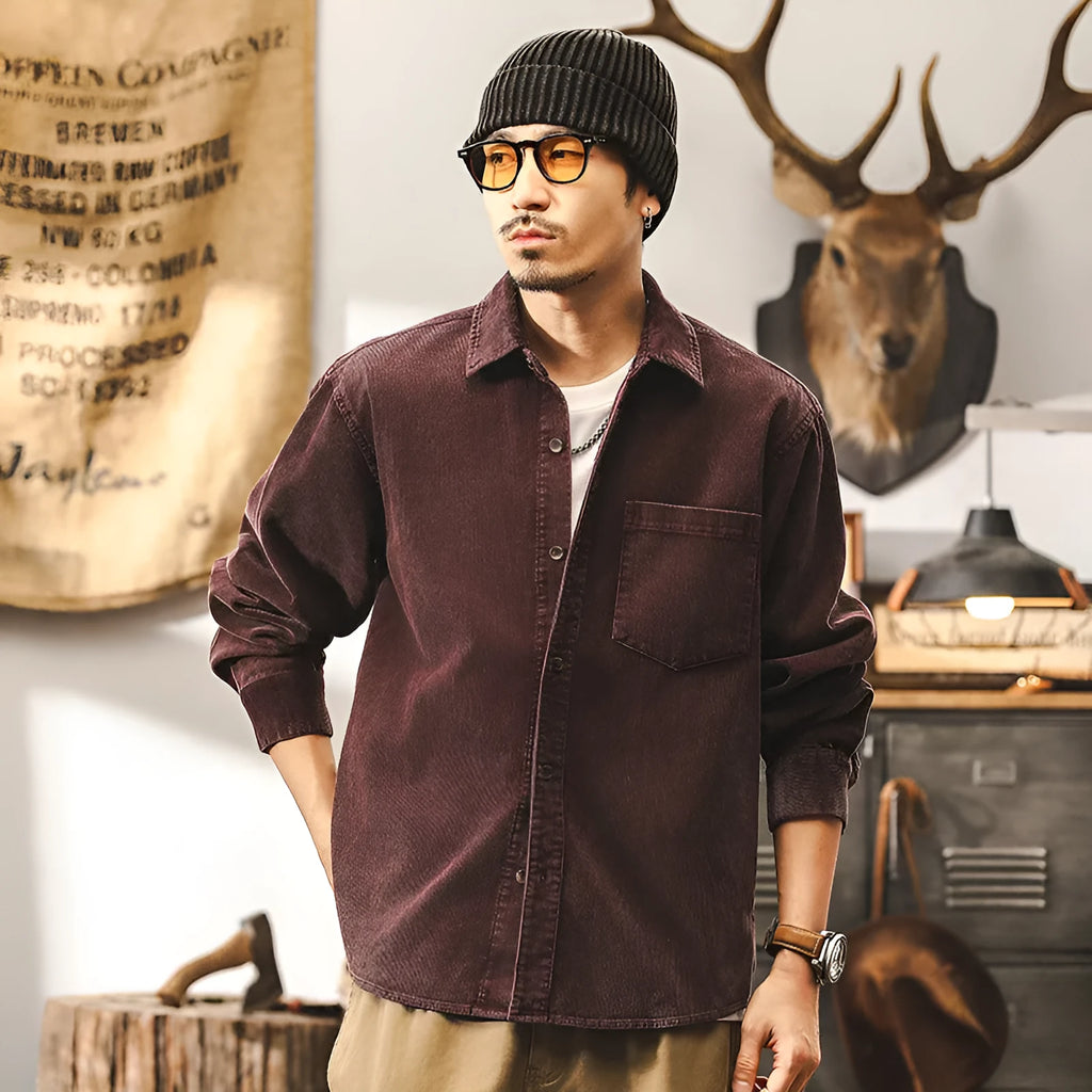 Men's loose-fit corduroy shirt jacket in red or black, showing long sleeves and button front.
