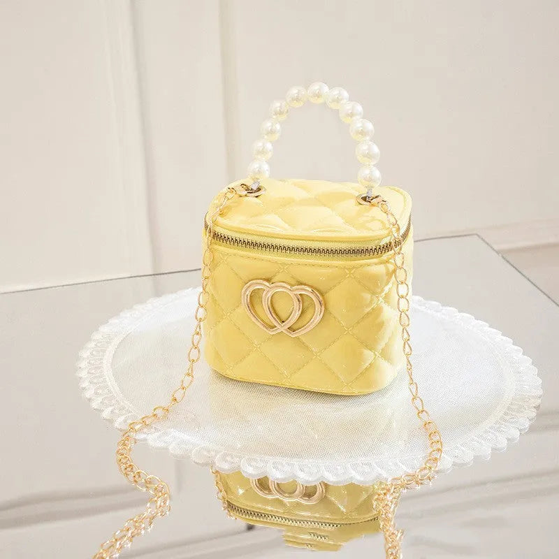 White PVC bucket bag with a red heart pattern, showing its shape and design.