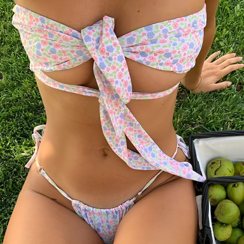 Women's lace-up front swimsuit with removable chest pad and split-leg cut in a floral print.