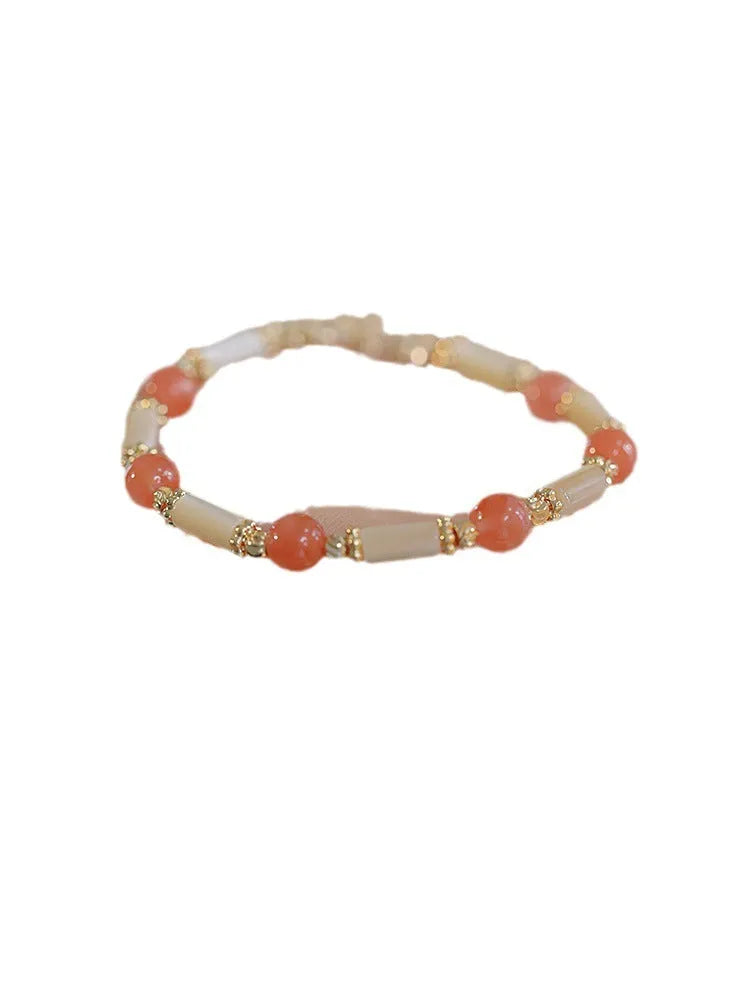 Women's Hetian jade bamboo joint bracelet in 6mm size, shown in jade and South red colours.