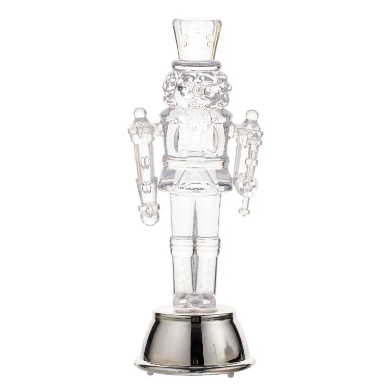Clear plastic walnut soldier nutcracker Christmas ornament on a desktop