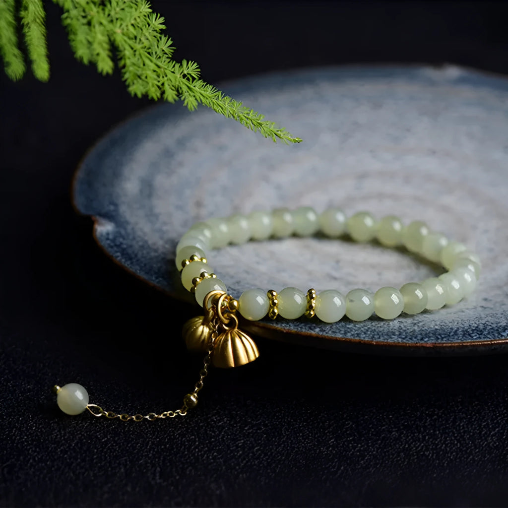 Natural Hetian Jade bracelet with Fu character detail on 6mm beads in a sunny water colour.