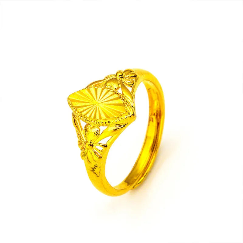 Gold-coloured brass ring with geometric open diamond flower pattern and textured surface